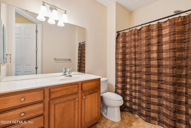 bathroom featuring tile patterned floors, vanity, and toilet