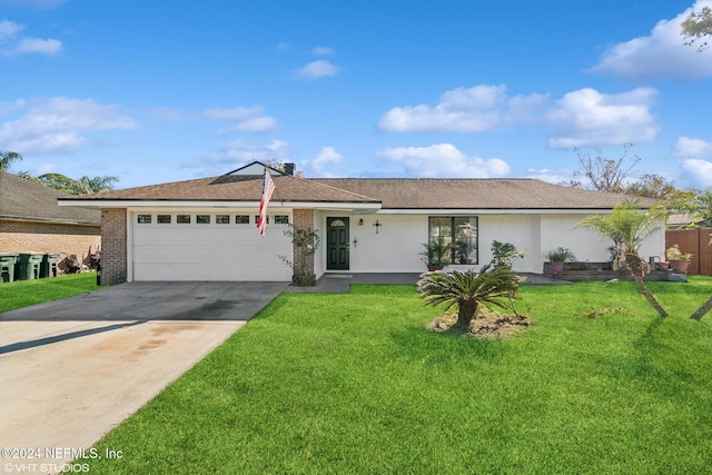 single story home featuring a garage and a front lawn