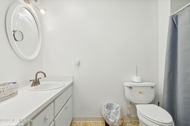 bathroom featuring tile patterned floors, vanity, and toilet