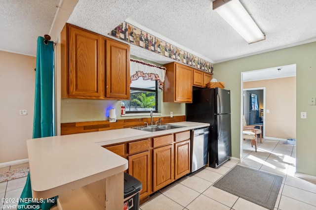 kitchen featuring sink, black fridge, stainless steel dishwasher, a textured ceiling, and light tile patterned flooring