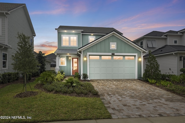 view of front of house featuring a lawn and a garage