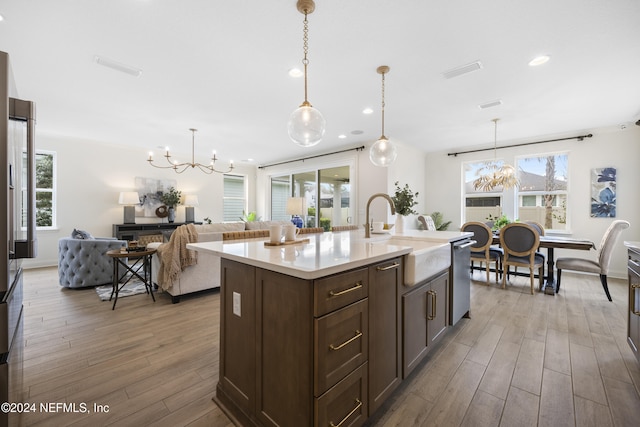 kitchen featuring plenty of natural light, an inviting chandelier, and hardwood / wood-style flooring