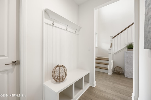 mudroom with light hardwood / wood-style floors