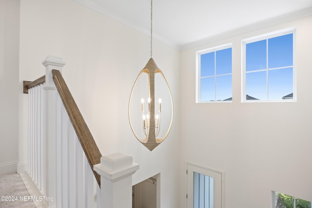 interior details featuring crown molding and a notable chandelier