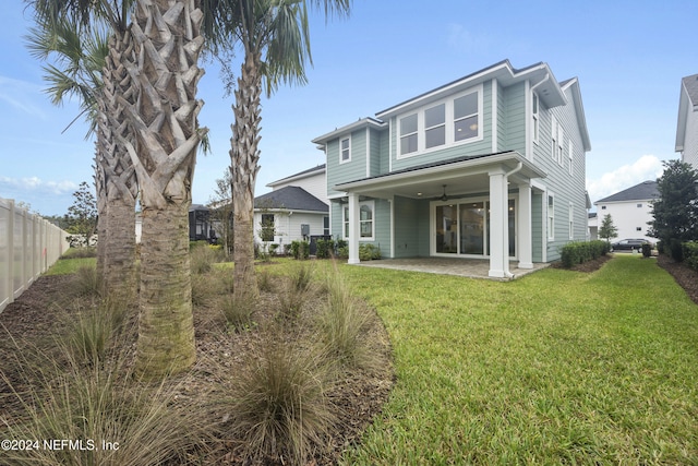 back of property featuring a yard and a patio area