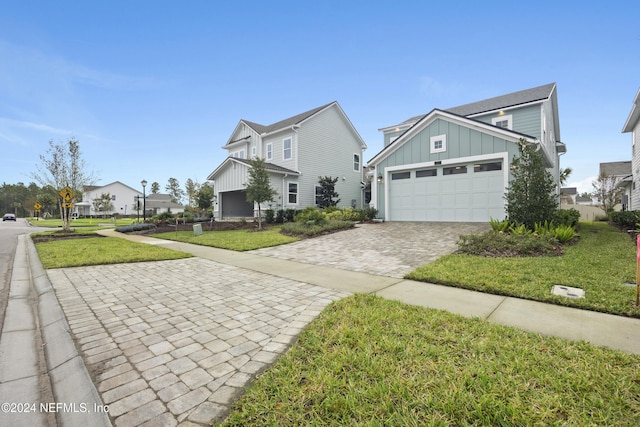 view of front of property featuring a garage and a front lawn