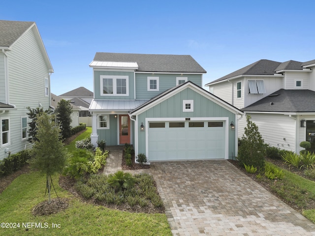 view of front of home featuring a garage and a front lawn