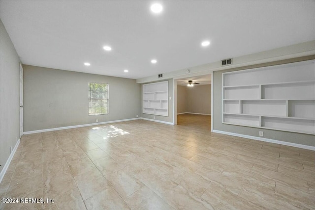 spare room featuring built in shelves