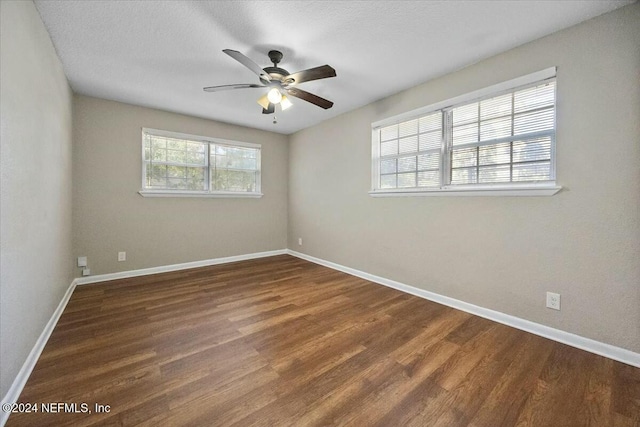 spare room featuring ceiling fan, dark hardwood / wood-style flooring, and a textured ceiling