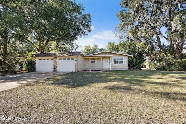 single story home with a garage and a front lawn