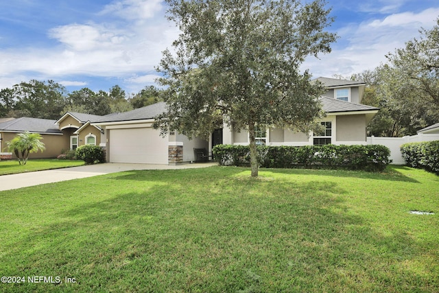 obstructed view of property with a garage and a front lawn