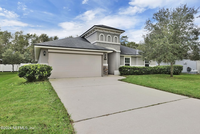 view of front of house with a garage and a front lawn