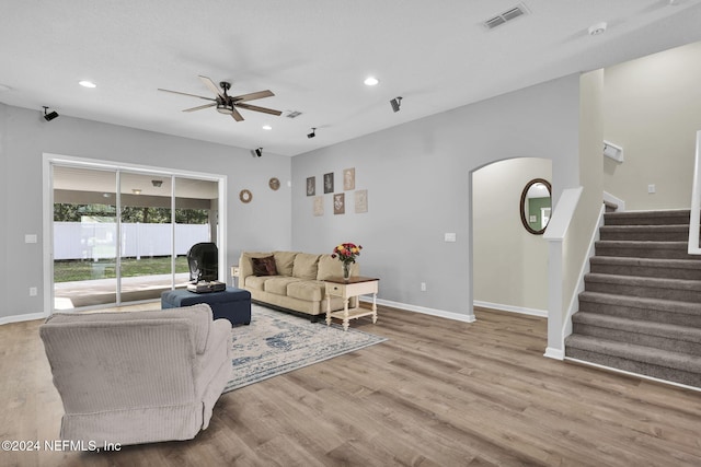 living room featuring light hardwood / wood-style floors and ceiling fan