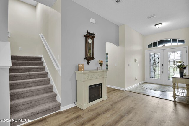 foyer featuring light hardwood / wood-style floors and french doors