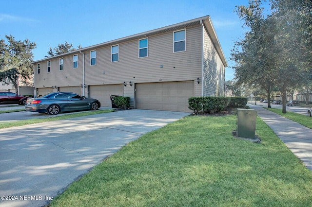 view of side of property with a garage and a yard