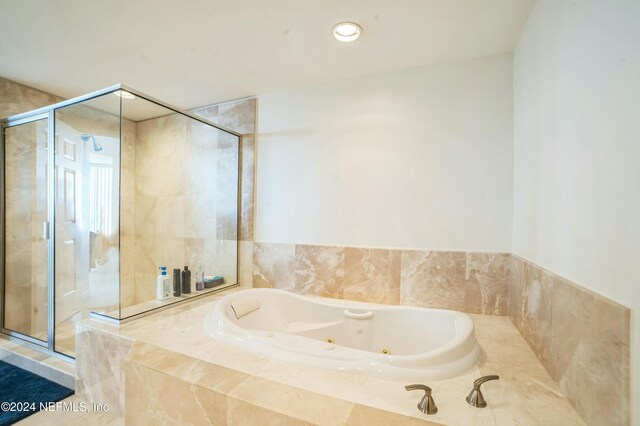 231 Riverside Dr Unit 1203-1, Daytona Beach, FL 32117 - full bathroom with a stall shower and a whirlpool tub