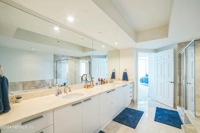 231 Riverside Dr Unit 1203-1, Daytona Beach, FL 32117 - bathroom featuring double vanity, a raised ceiling, a stall shower, recessed lighting, and tile patterned flooring