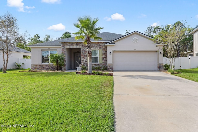 view of front of house featuring a front yard and a garage