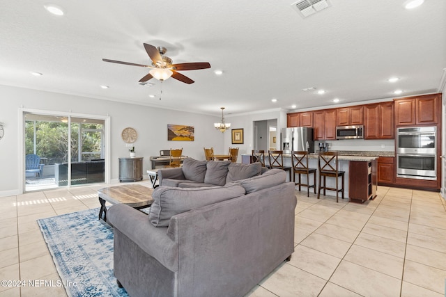 tiled living room with a textured ceiling, ceiling fan with notable chandelier, and crown molding