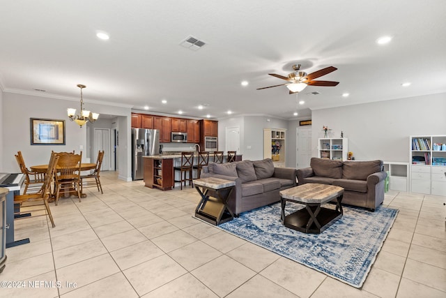 living room with light tile patterned floors, ceiling fan with notable chandelier, and crown molding