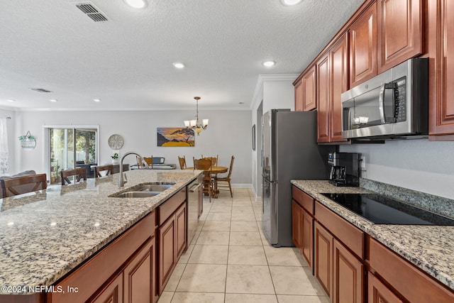 kitchen featuring light stone countertops, stainless steel appliances, an inviting chandelier, and sink