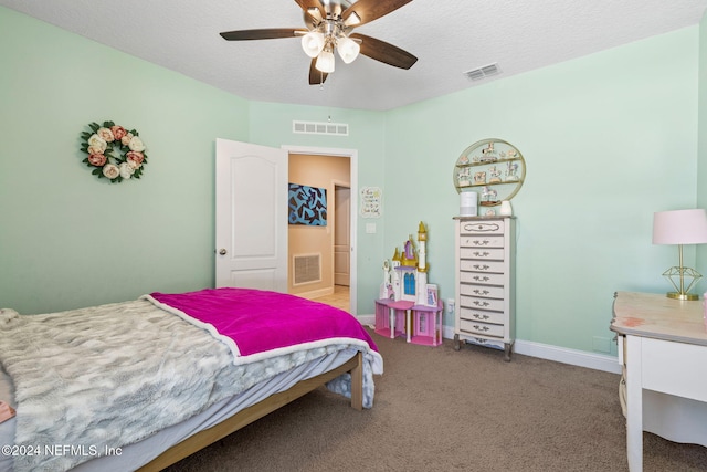 carpeted bedroom featuring ceiling fan and a textured ceiling