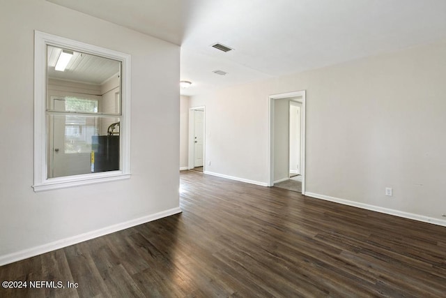 spare room featuring dark wood-type flooring