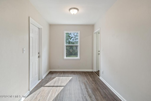 empty room featuring dark hardwood / wood-style flooring