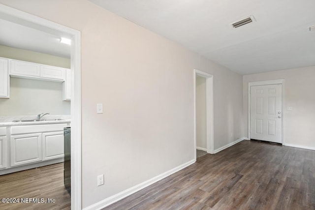 interior space with dark hardwood / wood-style flooring and sink