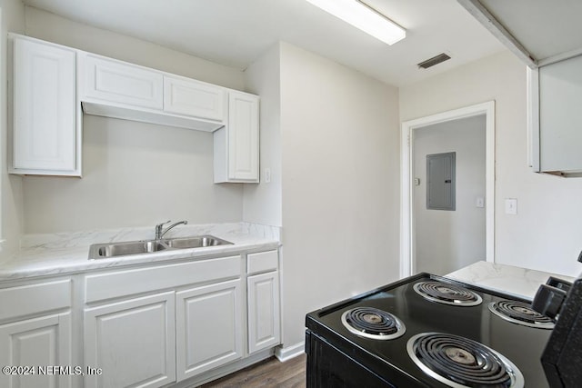 kitchen featuring white cabinetry, black range with electric cooktop, electric panel, and sink