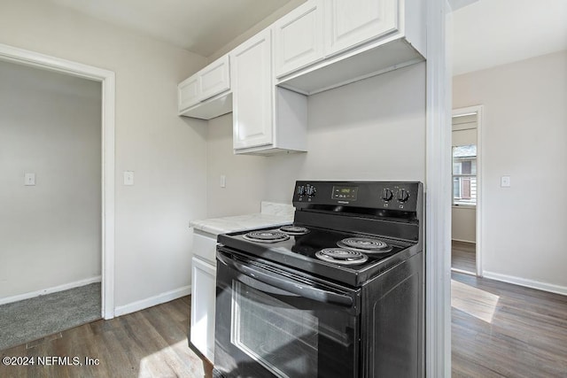 kitchen with white cabinetry, black electric range oven, and dark hardwood / wood-style floors