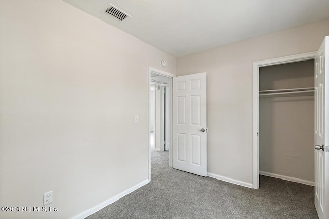 unfurnished bedroom featuring a closet and carpet