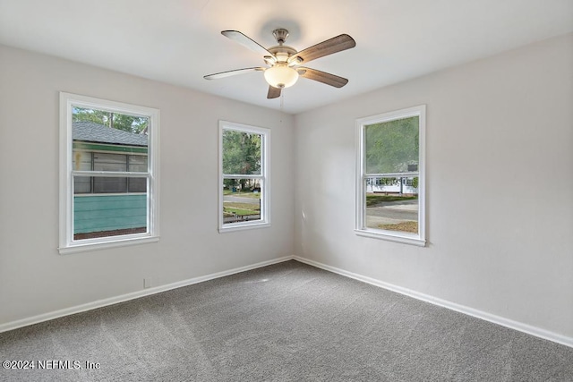 carpeted empty room featuring ceiling fan