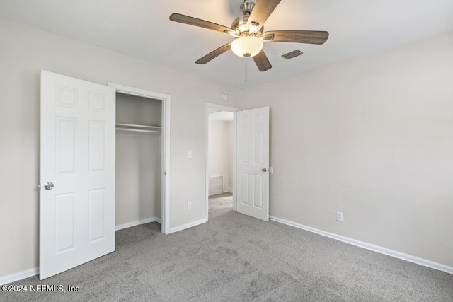 unfurnished bedroom featuring light carpet, a closet, and ceiling fan