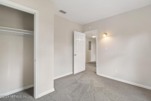 unfurnished bedroom featuring electric panel and carpet floors