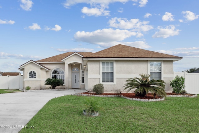 ranch-style home with a front lawn