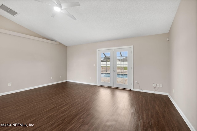 empty room with french doors, dark hardwood / wood-style flooring, a textured ceiling, ceiling fan, and lofted ceiling