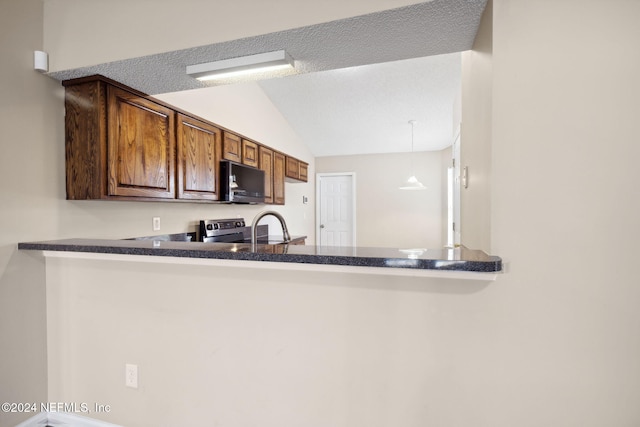 kitchen with stainless steel range with electric stovetop, decorative light fixtures, a textured ceiling, and vaulted ceiling