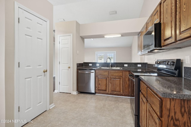 kitchen featuring sink, french doors, vaulted ceiling, light carpet, and appliances with stainless steel finishes