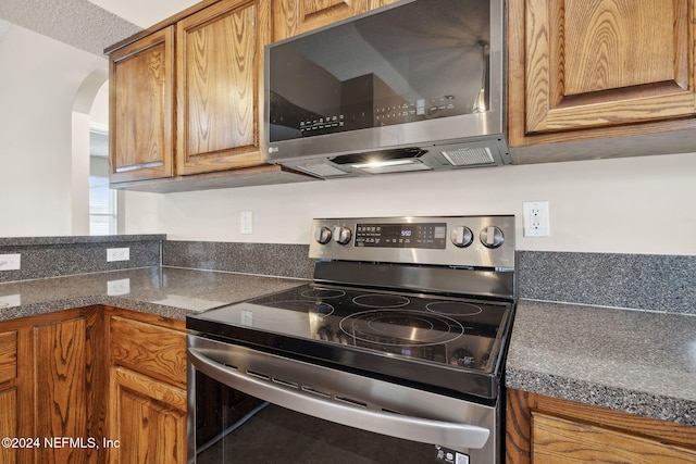 kitchen with a textured ceiling and stainless steel appliances