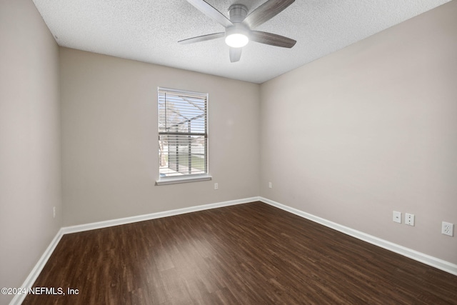 spare room with a textured ceiling, ceiling fan, and dark wood-type flooring