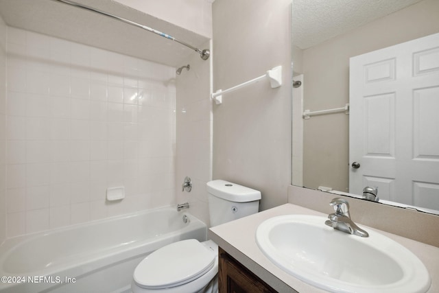 full bathroom featuring vanity, a textured ceiling, toilet, and tub / shower combination