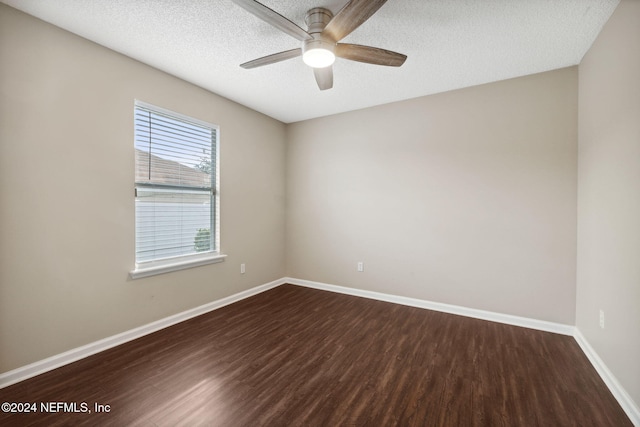 unfurnished room featuring dark hardwood / wood-style floors, ceiling fan, and a textured ceiling