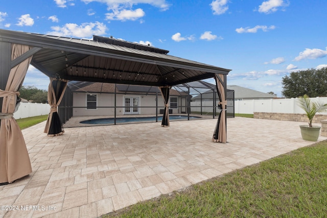 view of patio / terrace with a gazebo, a lanai, and a fenced in pool