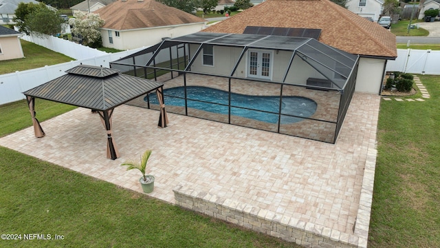 view of pool with a gazebo, a lanai, a patio, and french doors