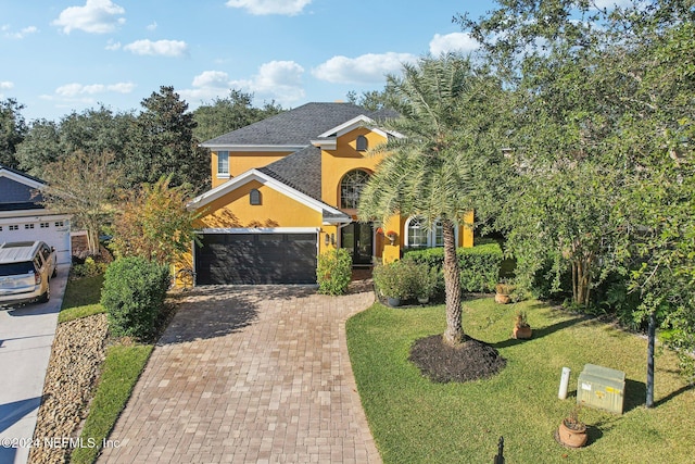 view of front of property with a garage and a front yard