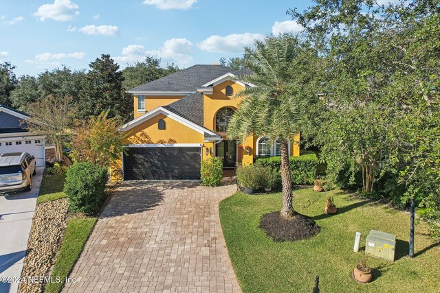 3370 Turkey Creek Dr, Green Cove Springs, FL 32043 - view of front of property featuring stucco siding, decorative driveway, a front yard, and a garage