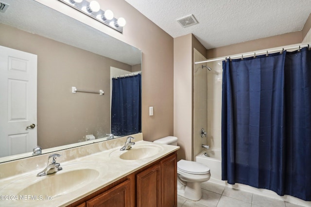 full bathroom featuring toilet, shower / bath combo, tile patterned floors, a textured ceiling, and vanity