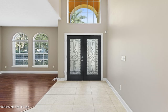 tiled foyer entrance featuring french doors