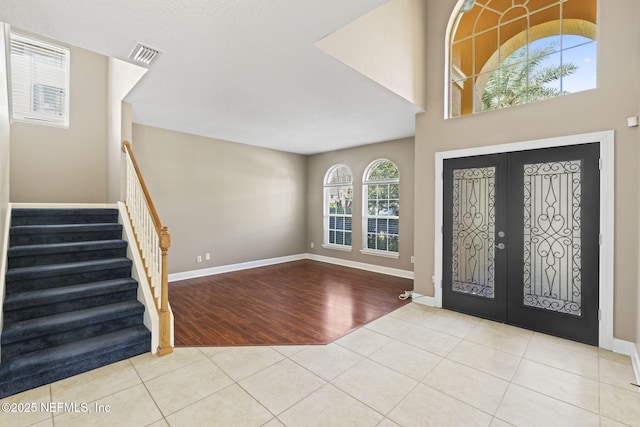 tiled entryway featuring french doors